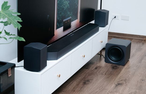 A tv and speakers on a standDescription automatically generated
